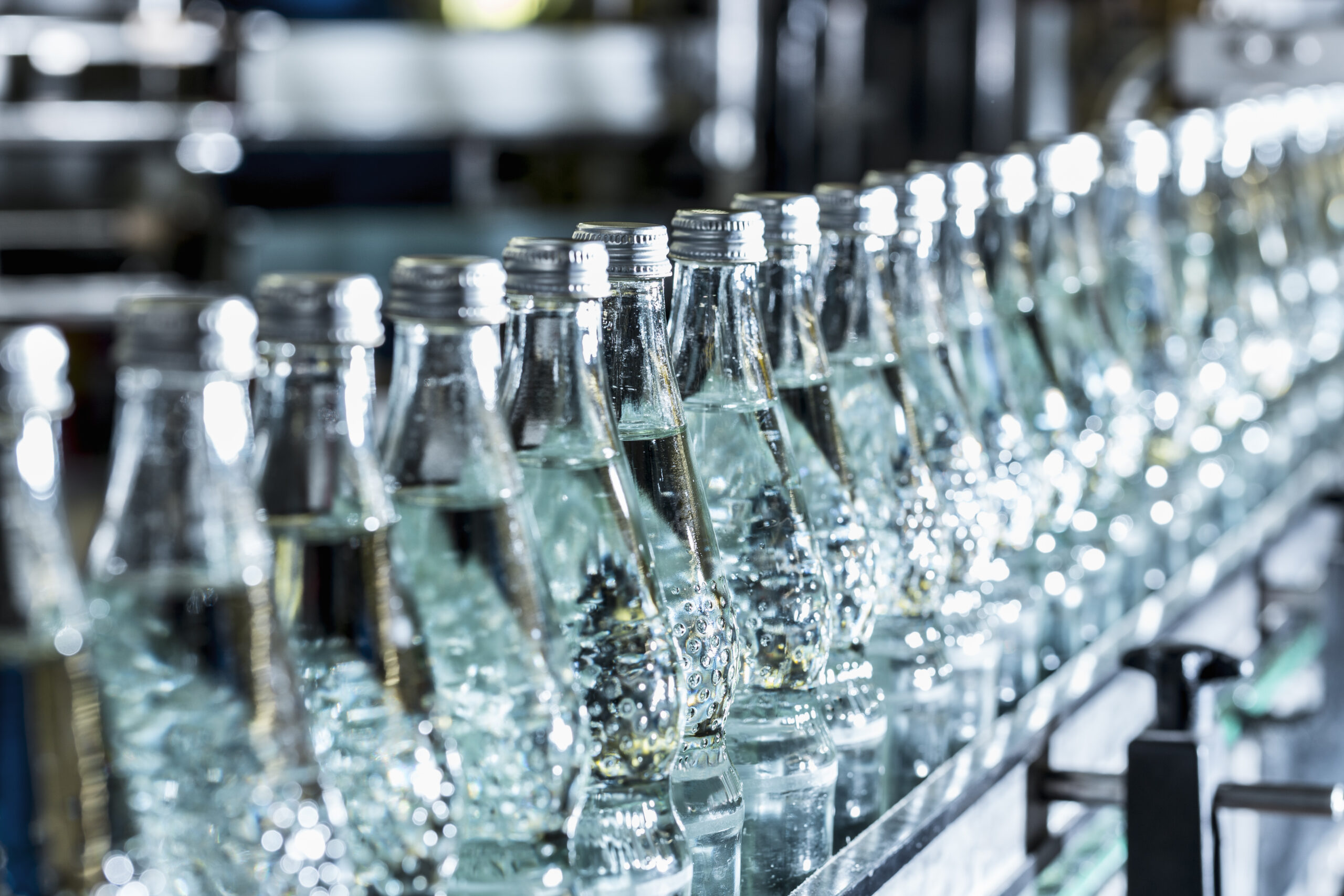 Row of mineral water bottles on conveyor belt